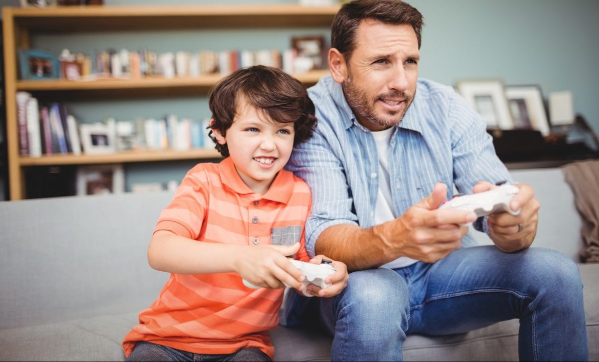 father and son playing video game after father wins custody using the help of Clinton Township child custody lawyers