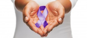 awareness ribbon in the hands of a Clinton Township domestic violence attorney