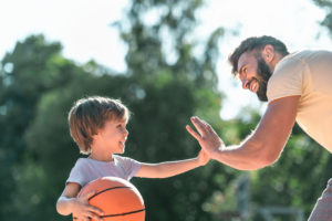 Father playing basketball with son, for dependable advice for child custody look to the Bloomfield Family Law Attorney.