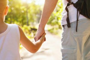 child holding parents hand representing how our Sterling Heights child custody lawyers can help you with your child custody case